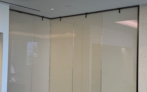 Santa Monica office conference room with its glass corner partition switched to frosted, a milky white