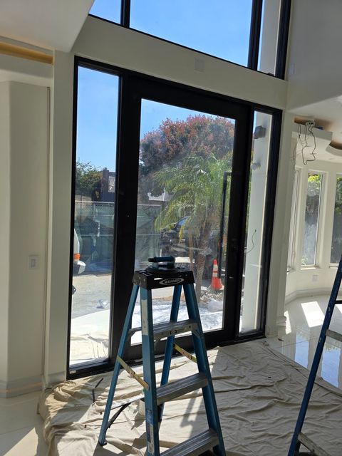 Installer preparing residential glass before a switchable film install