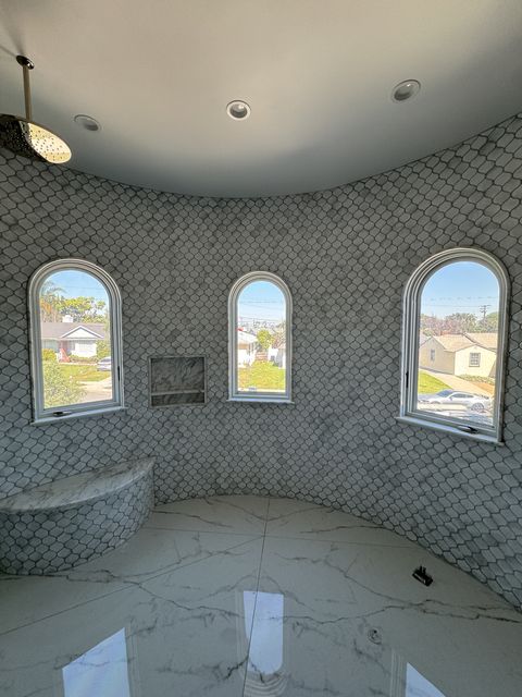 Smart glass shower Torrance — 65 sqft of PDLC switchable smart film custom-cut to six arched-top windows