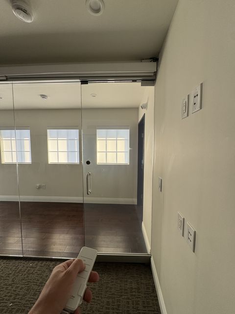 Hallway view of a smart glass office room in Hermosa Beach during a private call
