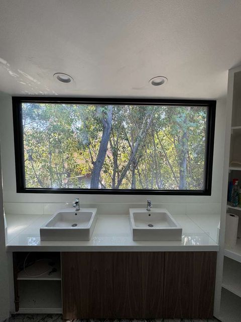 Large clear glass bathroom window before the switchable film retrofit