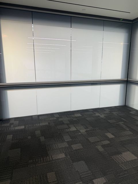 Real Smart View install: conference-room glass wall at Upper Deck in Carlsbad switched to its frosted state — the flat, even white surface that doubles as a projection screen