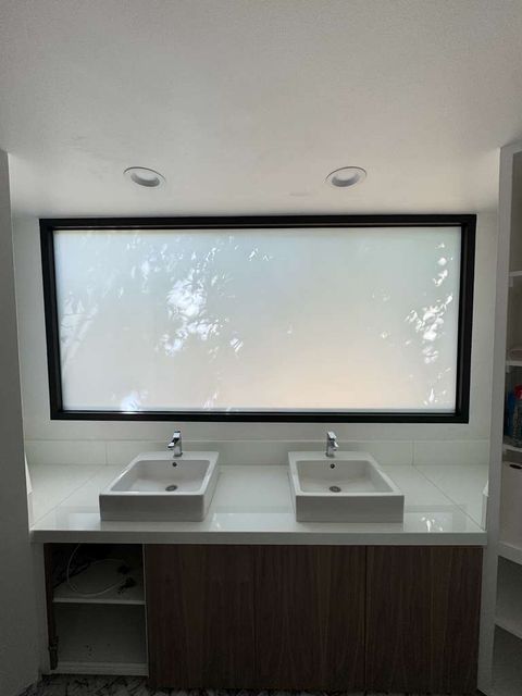 The same bathroom window after the switchable film retrofit, shown in frosted mode
