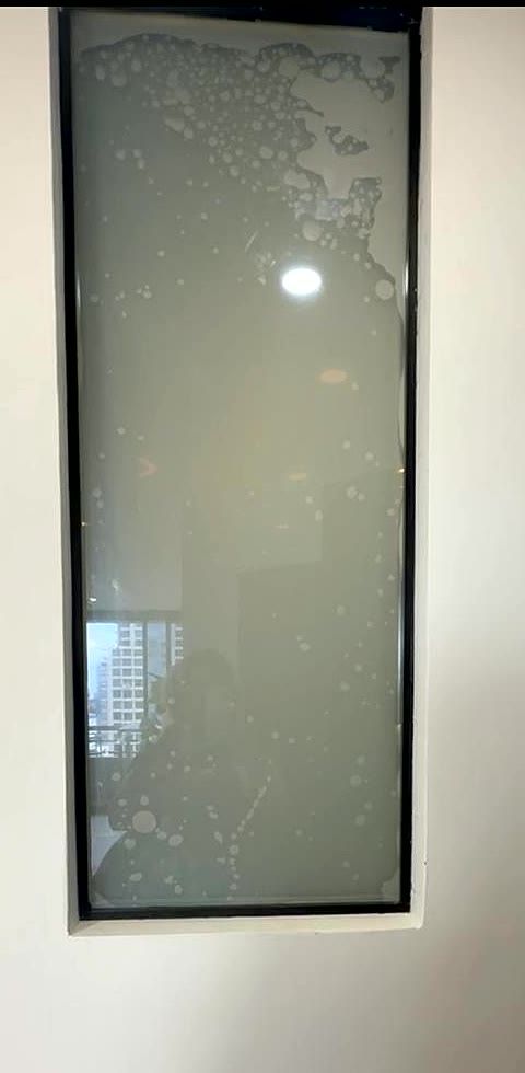 Smart film covered in trapped air bubbles from a botched DIY installation