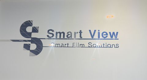 Smart film precision-cut into zebra, blinds-style horizontal bands across a window, showing both frosted and clear states