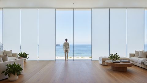El Segundo glass-walled private office with a floor-to-ceiling entry sidelight beside a wall of switchable smart glass — half the panels crystal clear to the open floor, half switched to flat, even, milky-white frosted privacy mode