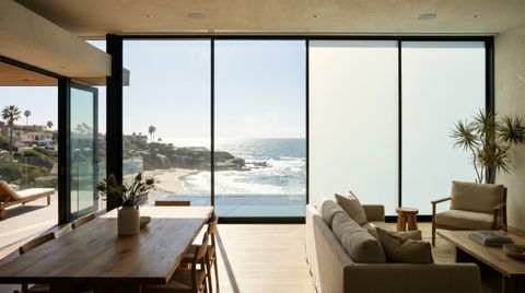 San Diego County coastal home above the La Jolla cliffs with a floor-to-ceiling clear switchable smart glass wall over the Pacific
