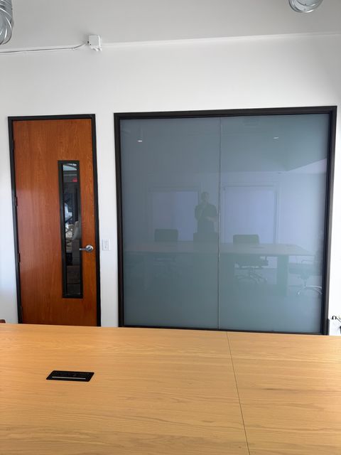 The same Newport Beach conference room partition switched to frosted privacy