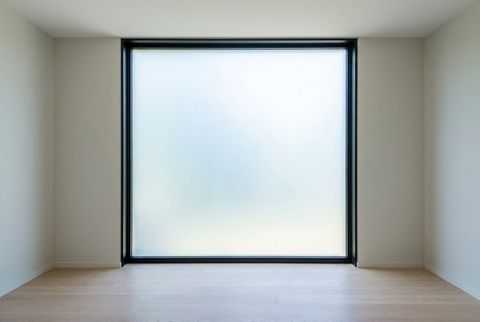 The same picture window powered off and frosted to an even milky-white for privacy