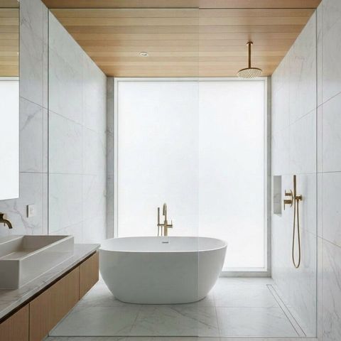 Luxury bathroom with the glass shower partition in its clear transparent state