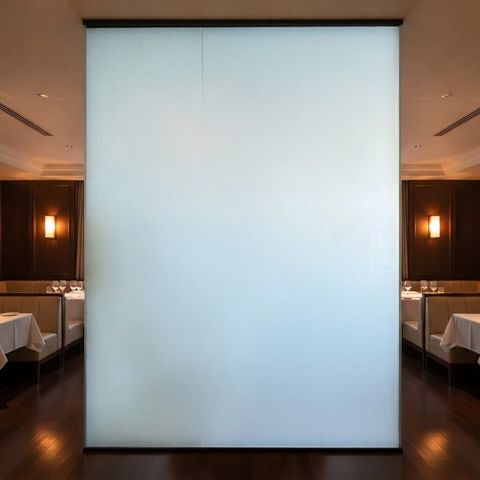 The same restaurant glass partition switched to frosted opaque privacy