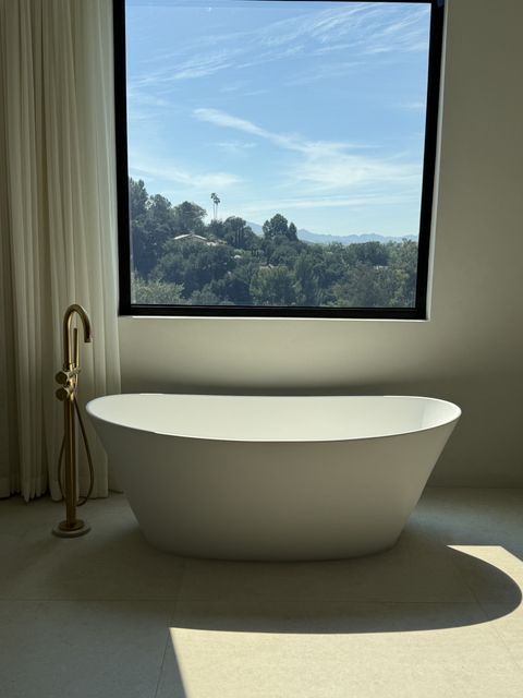 A real Smart View smart-film install in a luxury bathroom, powered on and crystal clear with a hillside view