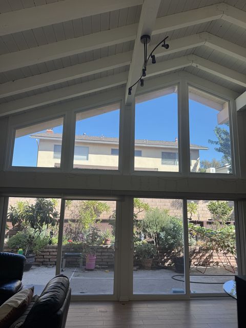 Irvine living room with four out-of-square gable windows clear, the neighbor's second story in view