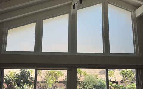 Smart glass gable windows in Irvine, four out-of-square living room windows frosted to privacy white