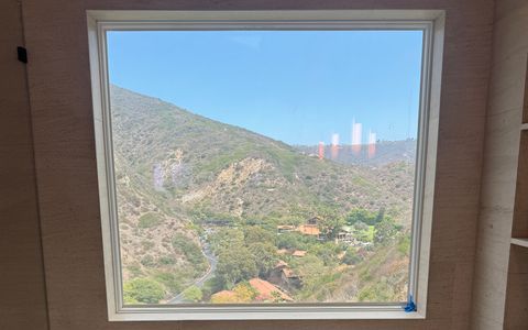 Smart film bathroom picture window in Laguna Beach in clear state, the canyon view filling the glass