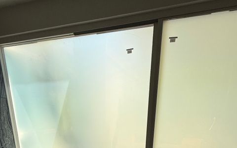Smart film whole-home retrofit in Palm Springs, bathroom courtyard glass switched to frosted privacy white
