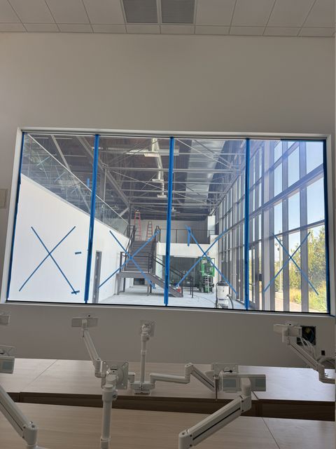 Los Angeles classroom smart glass window clear, looking through all four panels into the school commons and open stair