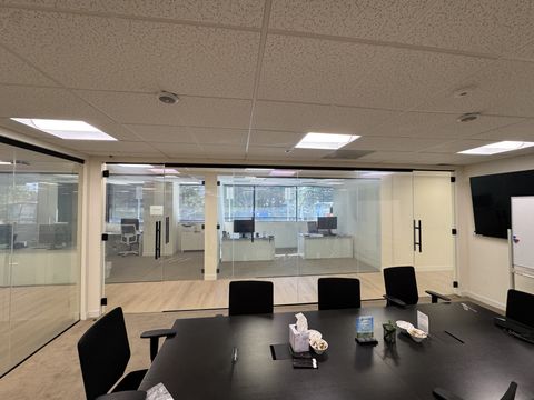 Thousand Oaks office conference room with the smart film glass wall clear, offices visible behind the twin glass doors