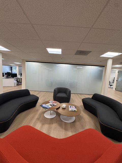 Lobby lounge in a Thousand Oaks office with the conference room glass wall frosted by smart film
