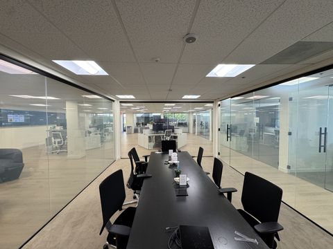 Long conference room in a Thousand Oaks office with clear smart film glass walls