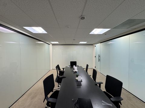Long conference room in a Thousand Oaks office with smart film glass walls switched to frosted
