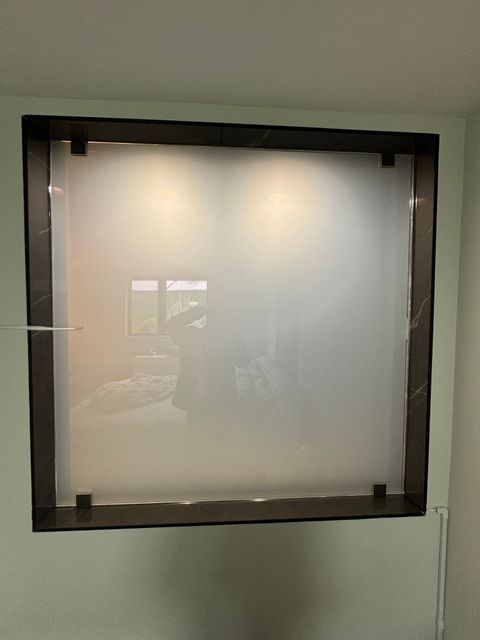 West Hollywood bedroom wall with the smart glass panel frosted, screening the bathroom completely