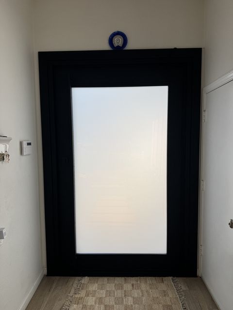 Frosted smart film door from across the Topanga entry hall, glass solid white