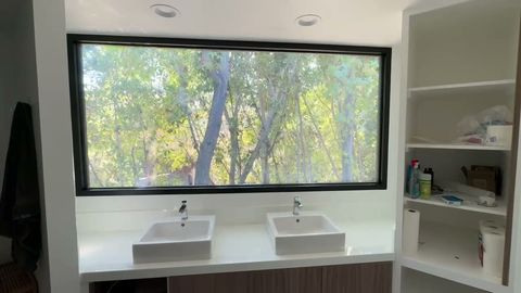 Pasadena bathroom window over a dual-sink vanity turning frosted on a wall switch