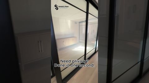 Corner meeting room with two glass walls switching to frosted for instant privacy