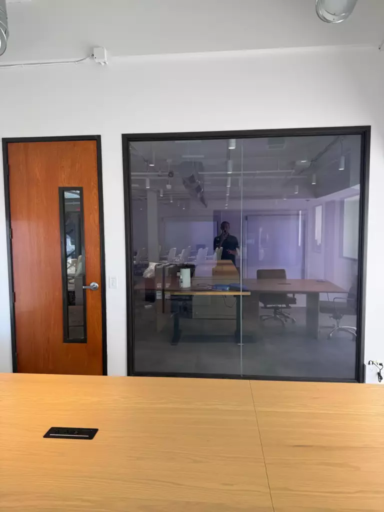 Switchable smart glass conference room wall in clear mode at office in Beverly Hills CA