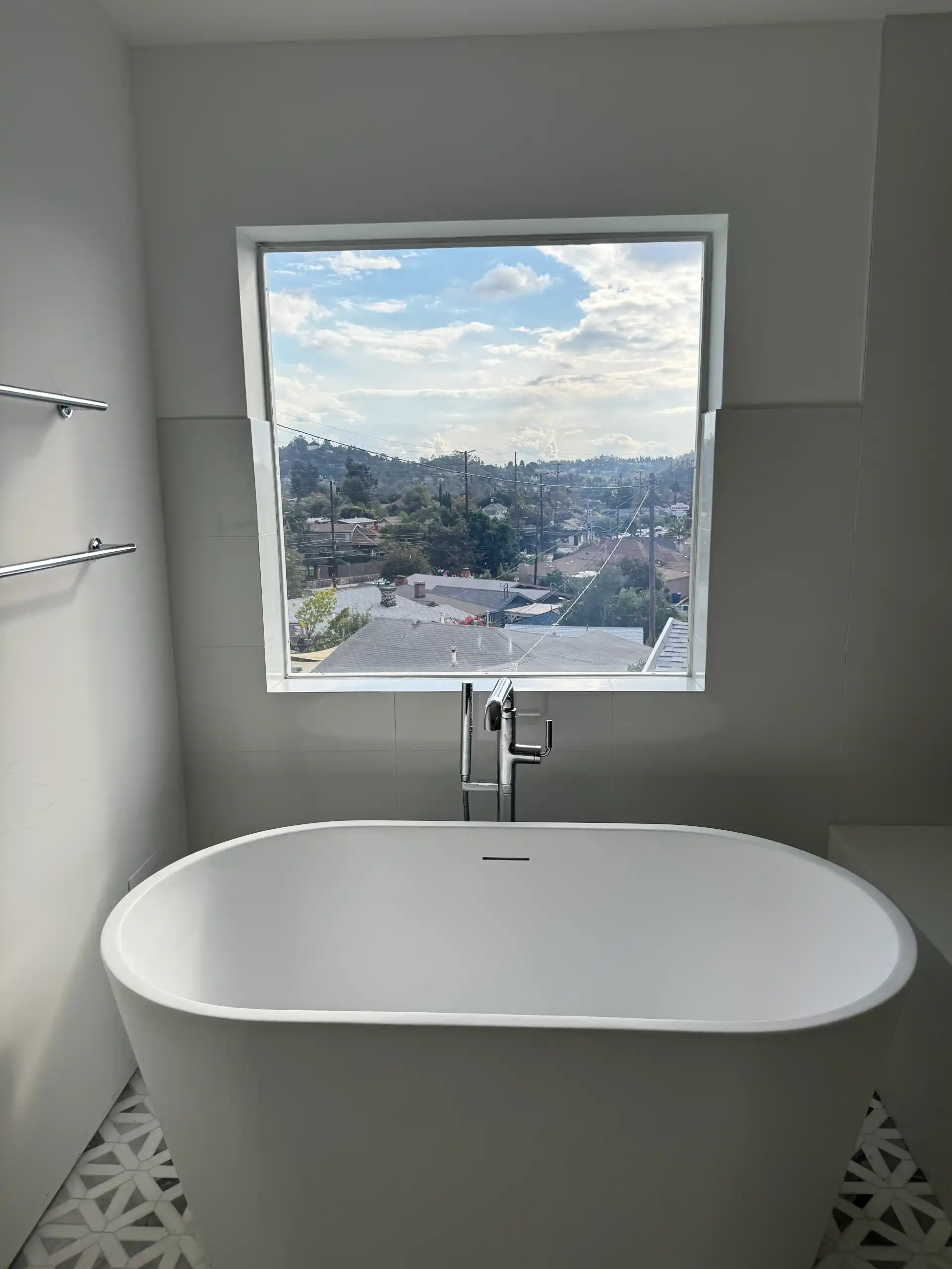 Smart glass bathroom window in Eagle Rock Los Angeles in clear mode above freestanding bathtub