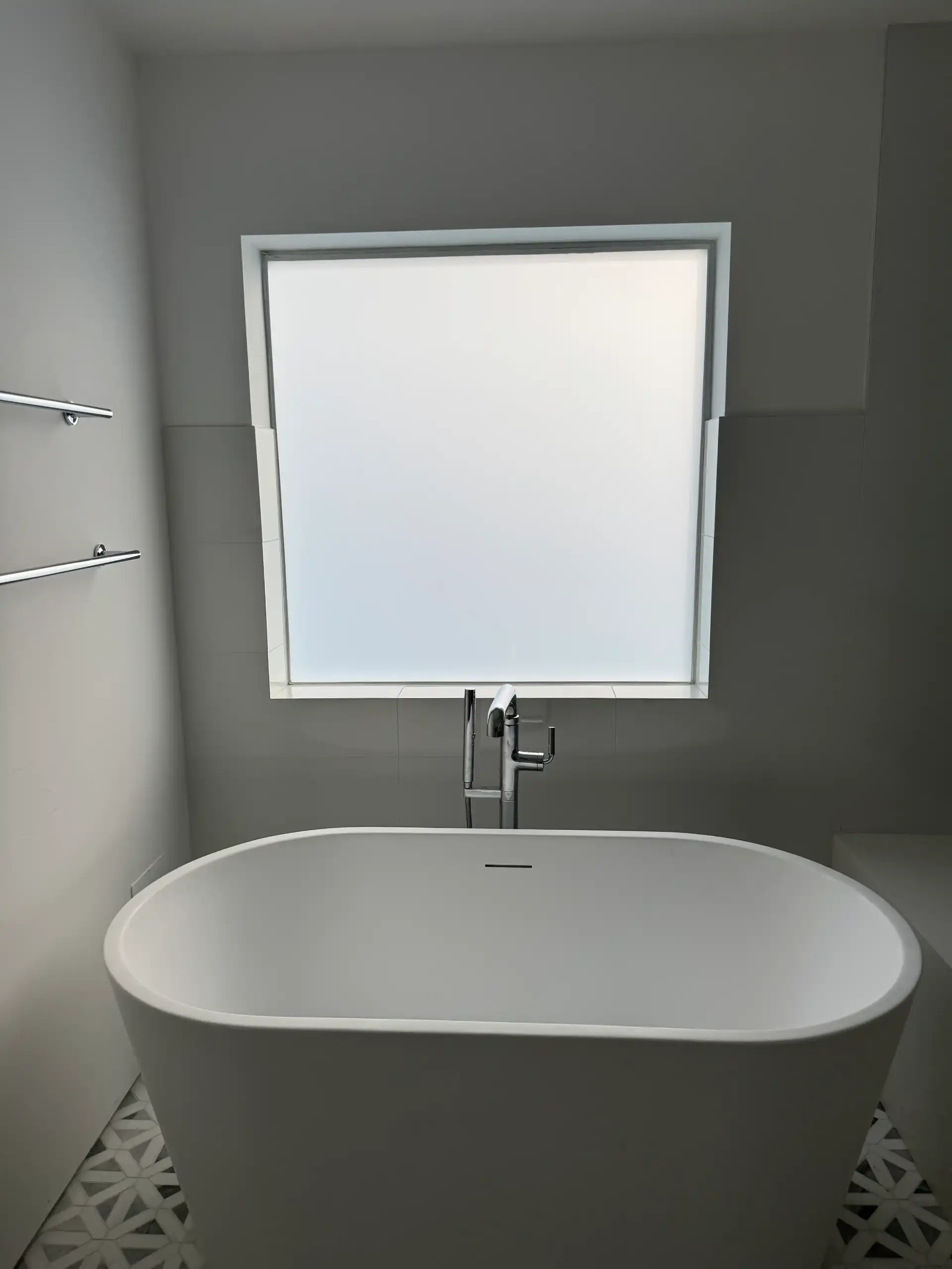 Smart glass bathroom window in Eagle Rock Los Angeles in privacy mode above freestanding bathtub