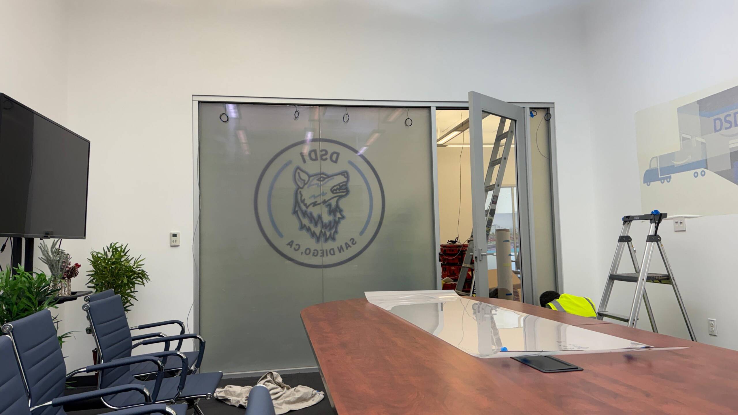 Smart film installation in progress on office conference room glass in San Diego CA
