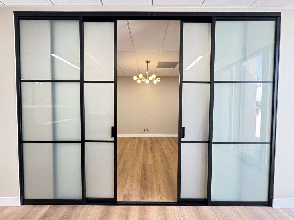 Modern sliding smart glass door in a Pasadena home, providing privacy and natural light control.