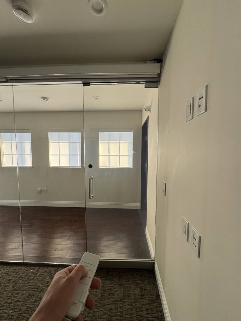 Hallway view of a smart glass office room in Hermosa Beach during a private call