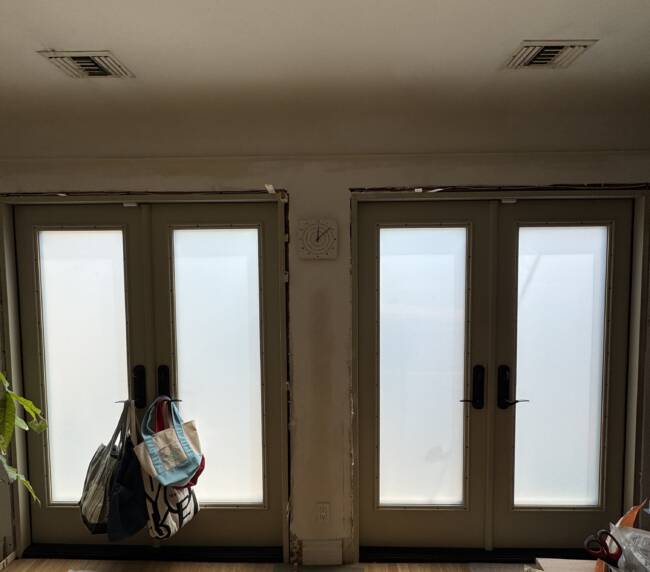 Switchable french doors in frosted privacy mode in a Los Angeles residence