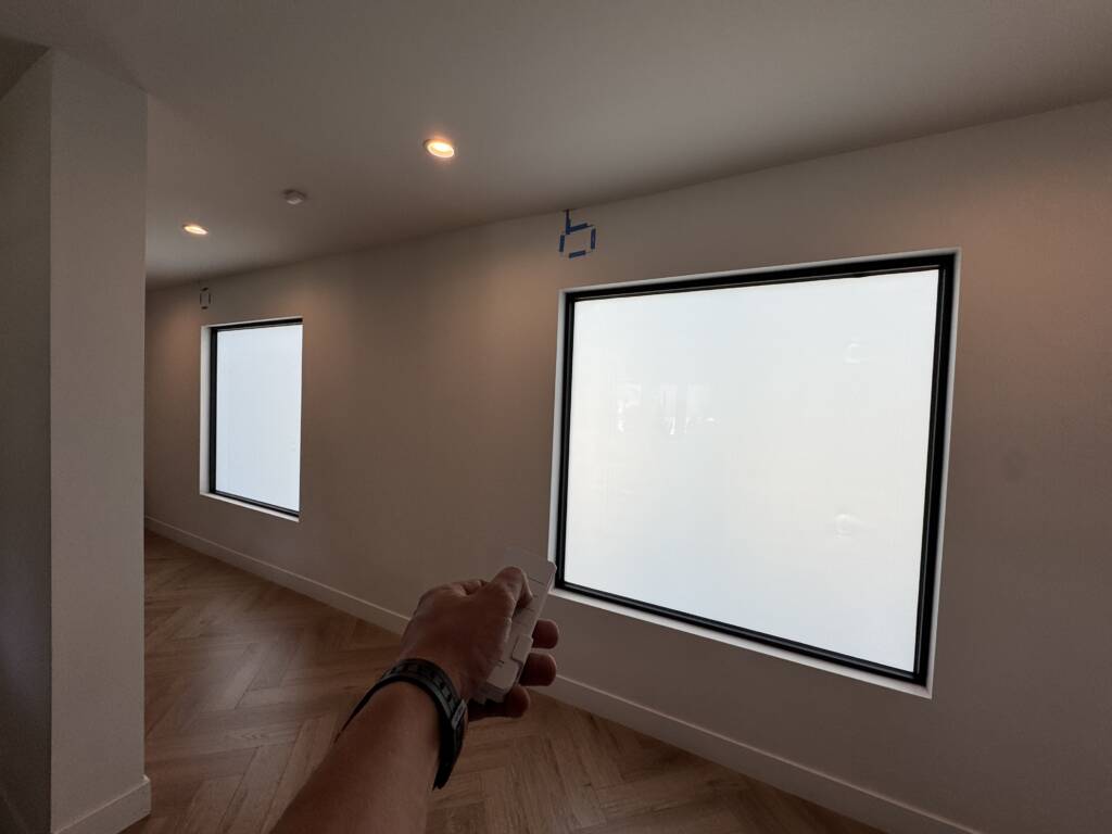Smart glass windows Tarzana — picture window and clerestory in frosted state with wireless remote toggling both together
