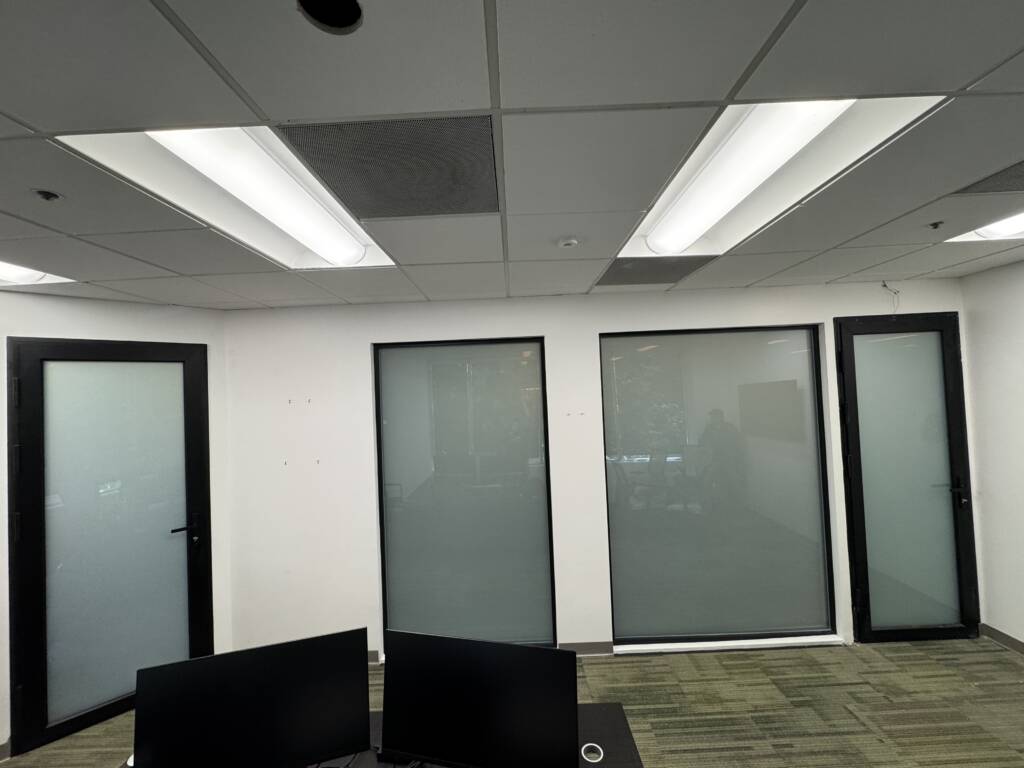 Modern privacy glass installation in Orange County featuring electronically controlled smart glass panels.