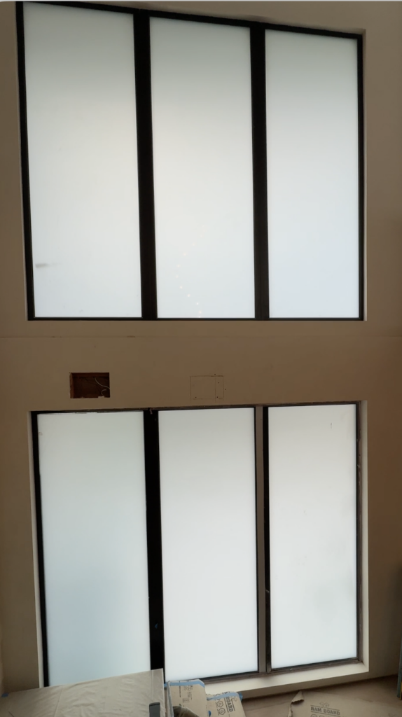 Smart glass windows Hollywood Hills install transitioning from clear to frosted at dusk