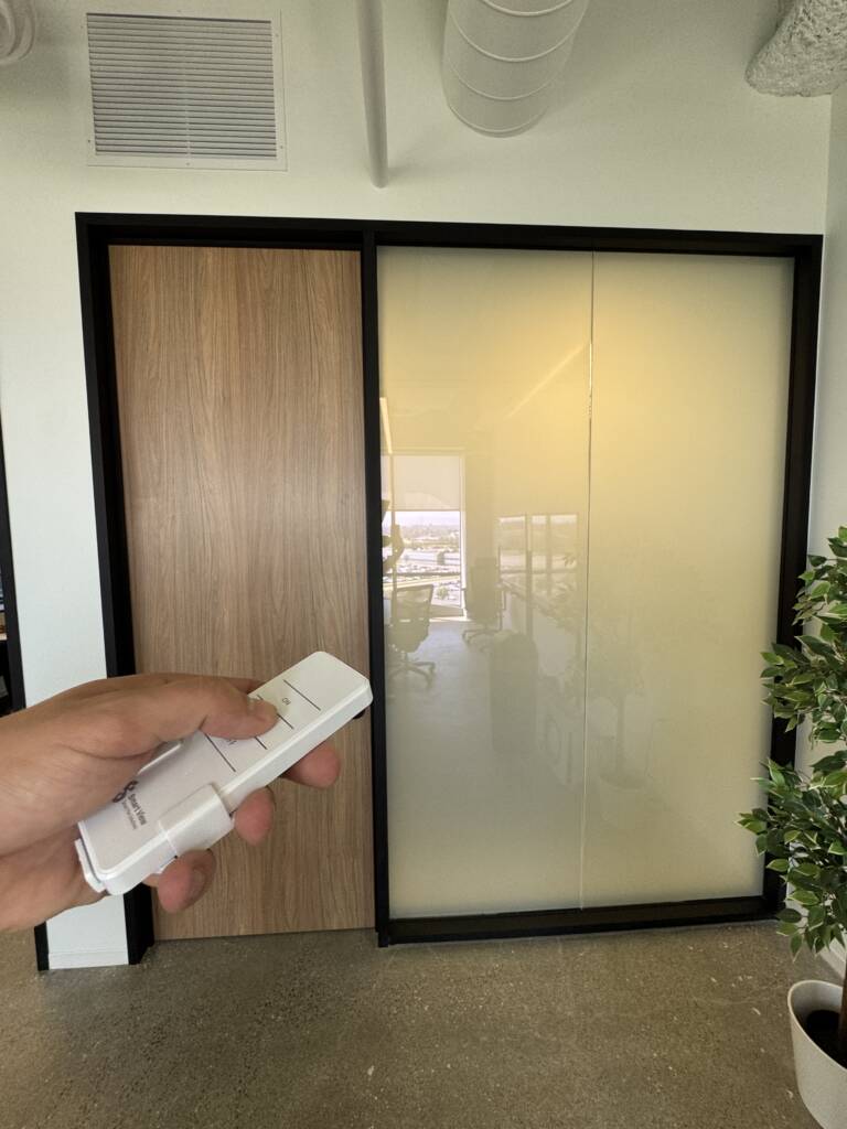 El Segundo PDLC smart glass partition frosted for privacy with remote in hand