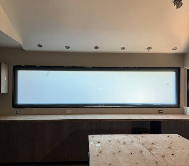 Smart glass kitchen Seal Beach &mdash; letterbox window in frosted state above lower cabinetry during construction